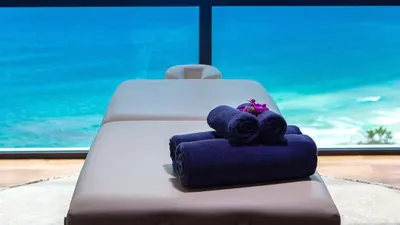 a wedding cake with towels on a table with a window at Villa Paradiso in Nai Thon Beach