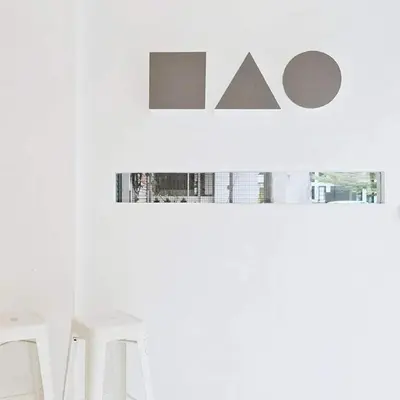 a row of white chairs in a white room at Hao Hostel Phuket in Phuket Town
