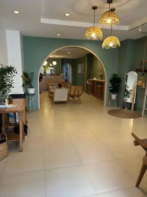 a lobby with an archway and tables and chairs at Sleep at Phuket SHA Plus in Phuket Town