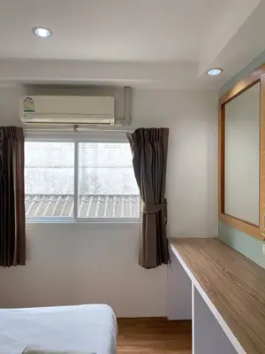 a bedroom with a bed and a window with a curtain at Sleep at Phuket SHA Plus in Phuket Town