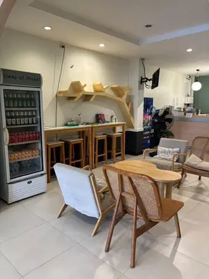 a kitchen with a table and chairs and a counter at Sleep at Phuket SHA Plus in Phuket Town