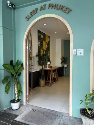 an entry way to a shop with a table in it at Sleep at Phuket SHA Plus in Phuket Town