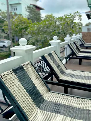 a row of chairs sitting on a balcony at Grand Supicha City Hotel in Phuket Town