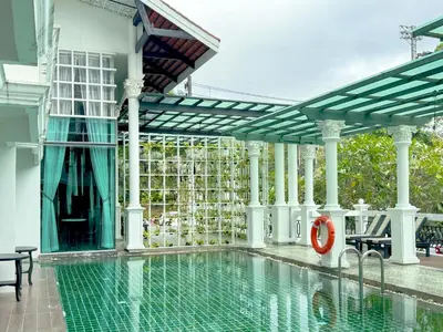 a swimming pool in a house with a swimming pool at Grand Supicha City Hotel in Phuket Town