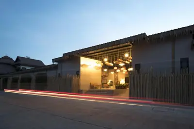 a building with lights on the side of a street at Ozone Villa Phuket in Ban Pa Khlok