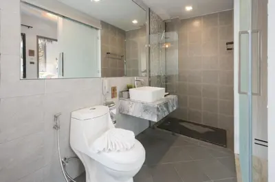 a bathroom with a white toilet and a sink at Ozone Villa Phuket in Ban Pa Khlok