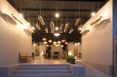 a lobby with a bunch of lights hanging from the ceiling at Ozone Villa Phuket in Ban Pa Khlok
