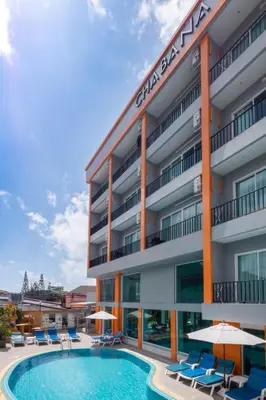 a hotel with a pool and chairs and umbrellas at Chabana Kamala Hotel in Kamala Beach