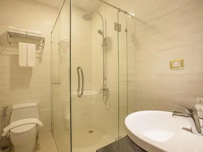 a bathroom with a shower and a toilet and a sink at Chabana Kamala Hotel in Kamala Beach