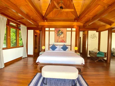 a bedroom with a large bed and wooden ceilings at Luxury Seaview Villa Surin Beach Phuket in Surin Beach