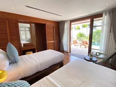 a hotel room with two beds and a balcony at Luxury Seaview Villa Surin Beach Phuket in Surin Beach