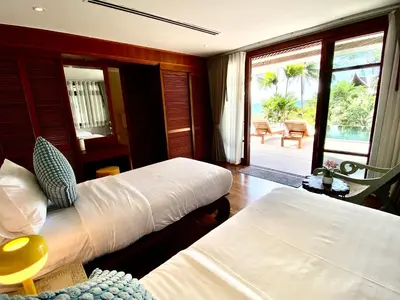 a bedroom with two beds and a view of the ocean at Luxury Seaview Villa Surin Beach Phuket in Surin Beach