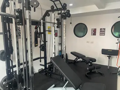a gym with several tread machines in a room at Skipper's Karon in Karon Beach