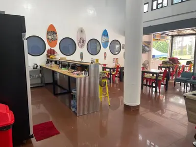 a room with tables and chairs and mirrors on the wall at Skipper's Karon in Karon Beach