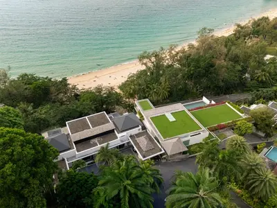 an aerial view of a resort with a tennis court and the beach at Bluesiam Villas - SHA Certified in Surin Beach
