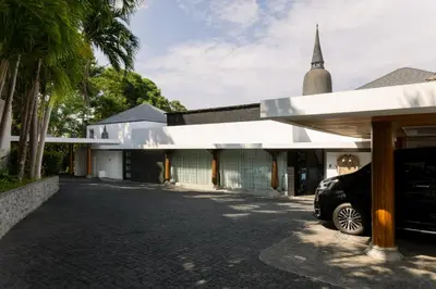 a church with a car parked in front of a building at Bluesiam Villas - SHA Certified in Surin Beach