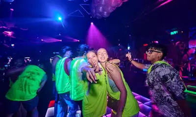 a group of young men dancing in a nightclub at Lub d Phuket Patong - Near Patong Beach & Vibrant Social Vibe in Patong Beach