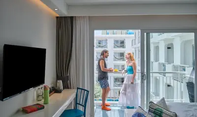 a man and a woman standing in a hotel room at Lub d Phuket Patong - Near Patong Beach & Vibrant Social Vibe in Patong Beach