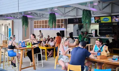 a group of people sitting at tables in a restaurant at Lub d Phuket Patong - Near Patong Beach & Vibrant Social Vibe in Patong Beach