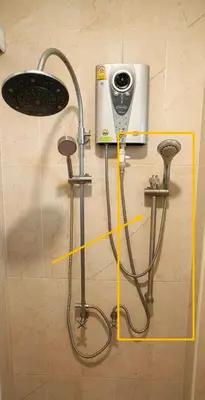 a bathroom with a shower head and a sink at Vacation Garden Villa in Thalang