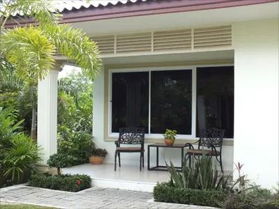 a patio with a table and chairs on a house at Vacation Garden Villa in Thalang
