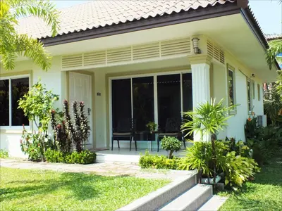 a house with glass doors and a patio at Vacation Garden Villa in Thalang