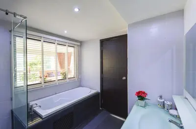 a bathroom with a tub and a sink and a window at BeststayinPhuket Mountain Poolviews in Patong Beach
