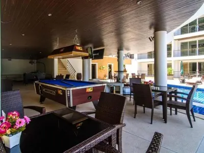 a pool room with a pool table and tables and chairs at BeststayinPhuket Mountain Poolviews in Patong Beach