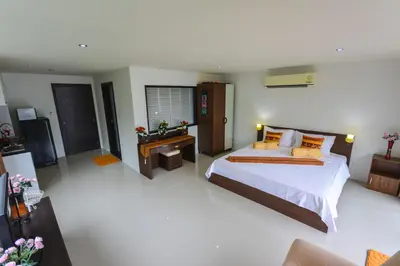 a bedroom with a large bed and a desk at BeststayinPhuket Mountain Poolviews in Patong Beach