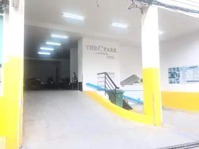 a gym with a yellow and white wall and a slide at The C Park in Patong Beach