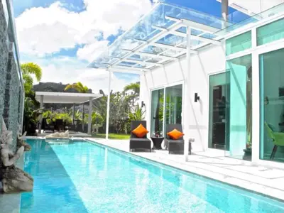 a swimming pool in front of a house at Skylight 2 bedrooms Villa in Kamala in Kamala Beach