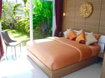 a bedroom with a bed and a chair and a window at Skylight 2 bedrooms Villa in Kamala in Kamala Beach