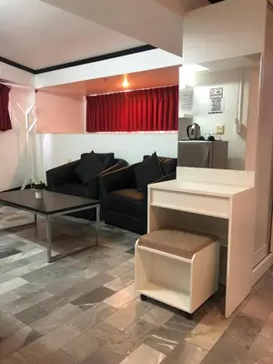 a living room with a couch and a table at Patong Holiday Dream Hotel in Patong Beach