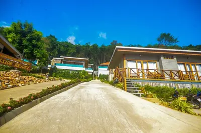 a dirt road leading to a house with flowers at Koh Yao Yai Hillside Resort in Ko Yao Yai