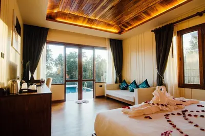 a bedroom with a bed and a couch in a room at Koh Yao Yai Hillside Resort in Ko Yao Yai