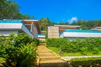 a house with a swimming pool next to a garden at Koh Yao Yai Hillside Resort in Ko Yao Yai