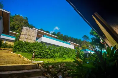 a building with stairs in front of a house at Koh Yao Yai Hillside Resort in Ko Yao Yai