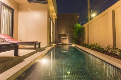 a swimming pool in the middle of a building at Honeymooner Pool Villa@Seastone in Bang Tao Beach