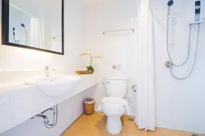 a white bathroom with a sink and a toilet at Vapa Hotel - SHA Extra Plus in Phuket Town