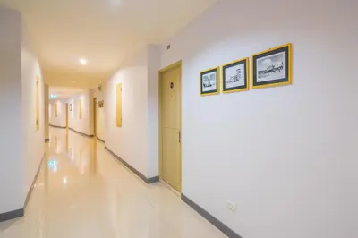 a hallway of a hospital with two pictures on the wall at Vapa Hotel - SHA Extra Plus in Phuket Town