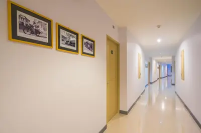 a hallway in a building with paintings on the walls at Vapa Hotel - SHA Extra Plus in Phuket Town