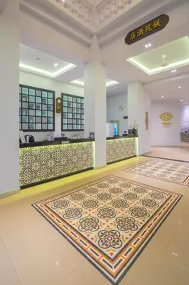 an empty lobby with a counter and a rug on the floor at Vapa Hotel - SHA Extra Plus in Phuket Town