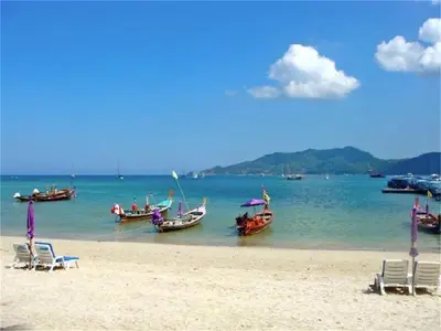 a group of boats in the water on a beach at Bliss Patong 2 bedrooms Apartment in Patong Beach