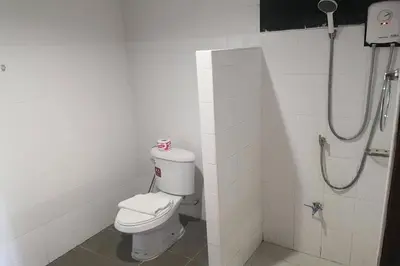 a bathroom with a toilet and a shower at JJ Residence Phuket Town in Phuket Town