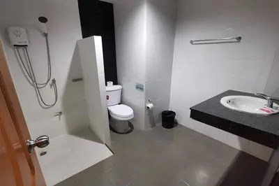a bathroom with a shower and a toilet and a sink at JJ Residence Phuket Town in Phuket Town