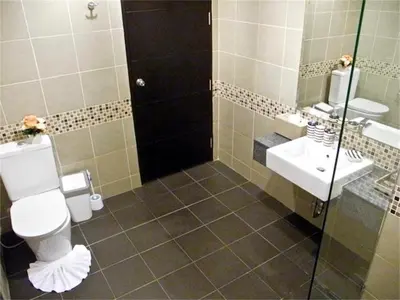 a bathroom with a toilet and a sink and a shower at Patong Bay Hill 1 bedroom Apartment in Patong Beach