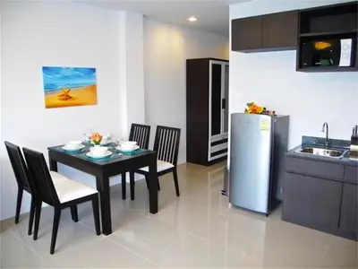 a kitchen and dining room with a table and a refrigerator at Patong Bay Hill 1 bedroom Apartment in Patong Beach