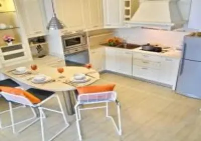 a kitchen with a table and chairs and a refrigerator at Patong Tower 1-Bedroom Apartment Full Sea View in Patong Beach