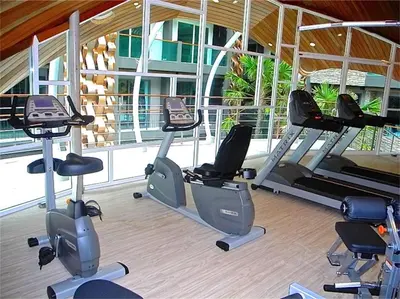 a gym with several exercise bikes in a room at Emerald Patong 1 bedroom Apartment Garden View in Patong Beach