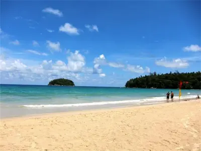 a group of people walking on the beach at Chic Karon Nice Apartment close to Karon Beach in Karon Beach